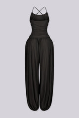 Tank top jumpsuit featuring draped cowl neckline with adjustable straps, Subtle horizontal ruched gathering across, Heavy gathering pants that taper at the bottom with elasticized ankle cuffs