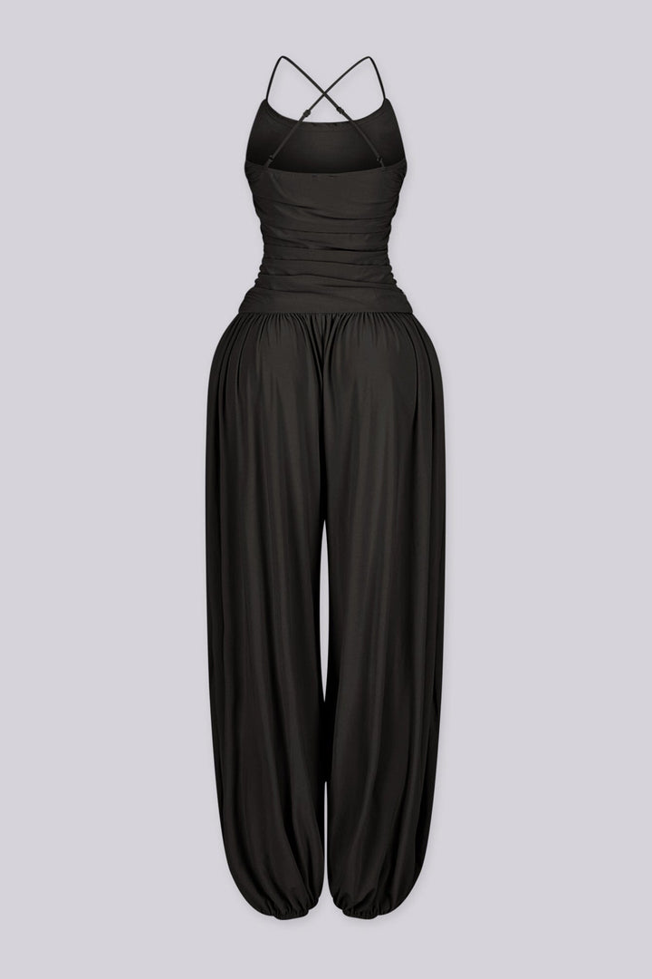 Tank top jumpsuit featuring draped cowl neckline with adjustable straps, Subtle horizontal ruched gathering across, Heavy gathering pants that taper at the bottom with elasticized ankle cuffs