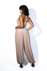 Tank top jumpsuit featuring draped cowl neckline with adjustable straps, Subtle horizontal ruched gathering across, Heavy gathering pants that taper at the bottom with elasticized ankle cuffs
