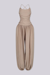 Tank top jumpsuit featuring draped cowl neckline with adjustable straps, Subtle horizontal ruched gathering across, Heavy gathering pants that taper at the bottom with elasticized ankle cuffs