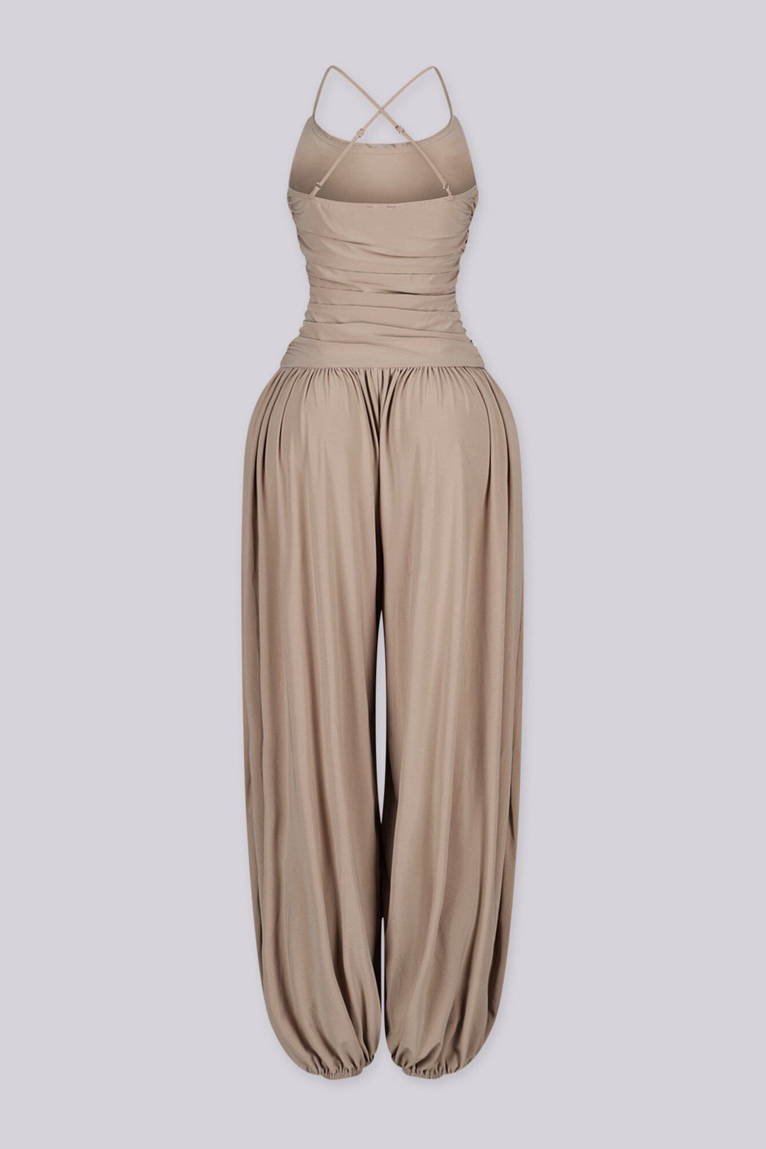 Tank top jumpsuit featuring draped cowl neckline with adjustable straps, Subtle horizontal ruched gathering across, Heavy gathering pants that taper at the bottom with elasticized ankle cuffs