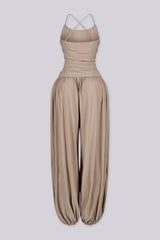 Tank top jumpsuit featuring draped cowl neckline with adjustable straps, Subtle horizontal ruched gathering across, Heavy gathering pants that taper at the bottom with elasticized ankle cuffs