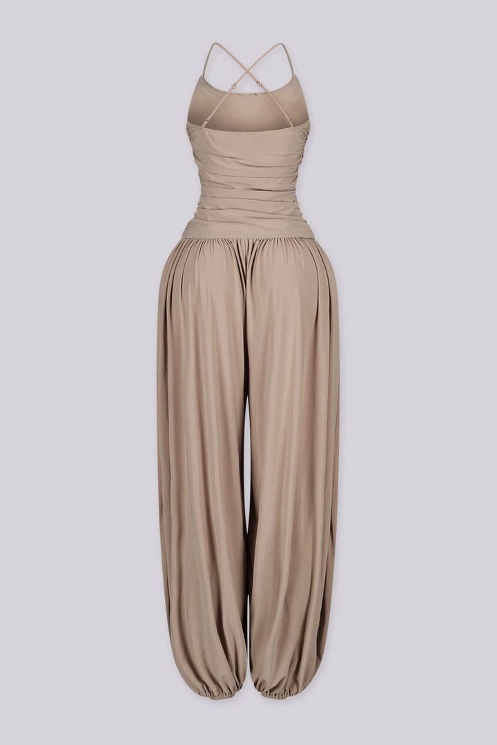 Tank top jumpsuit featuring draped cowl neckline with adjustable straps, Subtle horizontal ruched gathering across, Heavy gathering pants that taper at the bottom with elasticized ankle cuffs