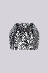 Low rise mini skirt fully covered in oversized metallic sequins and shimmering disc paillettes