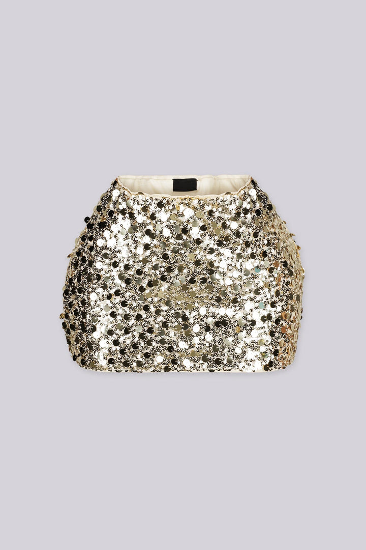 Low rise mini skirt fully covered in oversized metallic sequins and shimmering disc paillettes