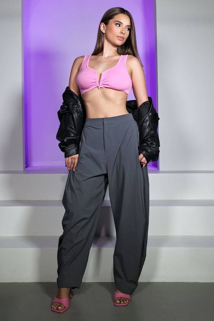 High waisted balloon shape cropped pants featuring tapered ankle cuffs with a snap button closured hem