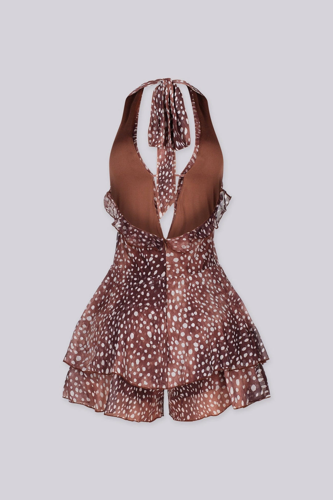 Polka dot deep plunging halter neckline romper featuring cascading ruffle trim along the center front
Adjustable halter tie strap at nape