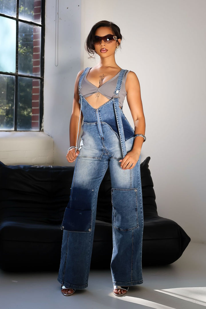Denim wide leg overall jumpsuit featuring adjustable straps and snap pockets
