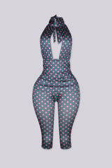 Sleeveless retro polka dot print jumpsuit with high mock collar featuring keyhole cutout opens below the collar