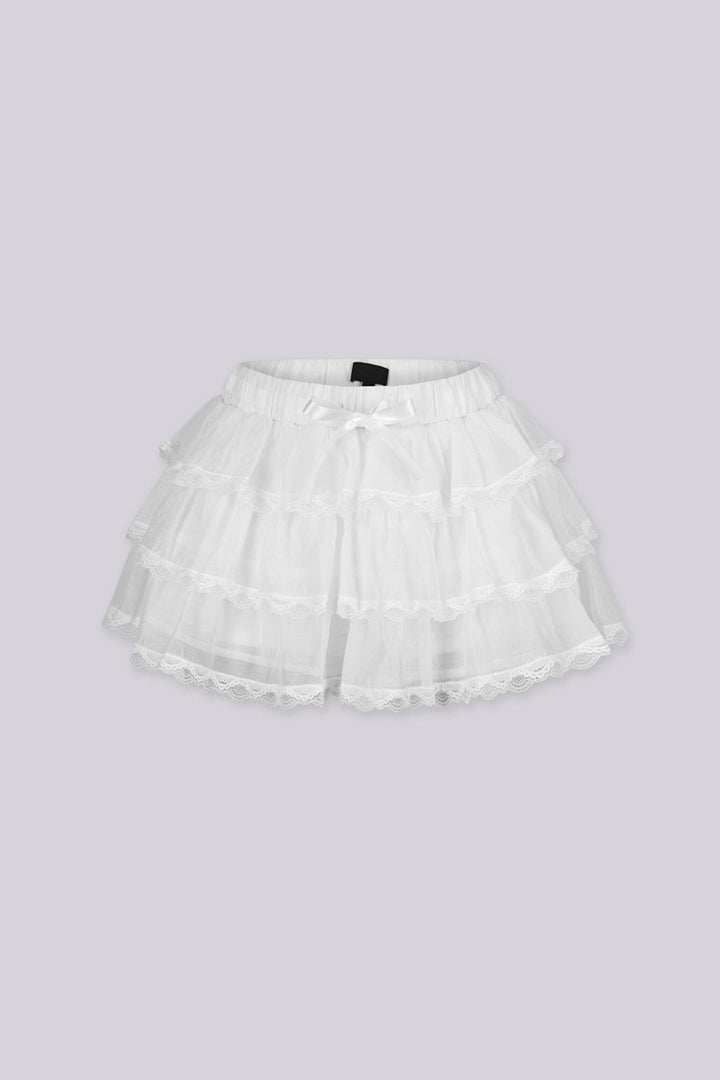 Low rise mini skort featuring ruffle lace trim and ribbon ties at the front
