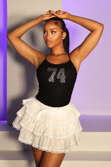 Low rise mini skort featuring ruffle lace trim and ribbon ties at the front