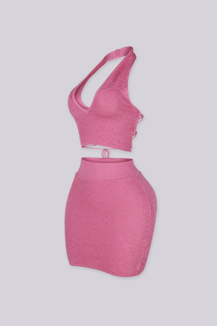 knit halter crop top with deep V plunge neckline featuring crisscross lace up eyelet closure
Matching high waisted bodycon mini skirt with wide elastic waistband