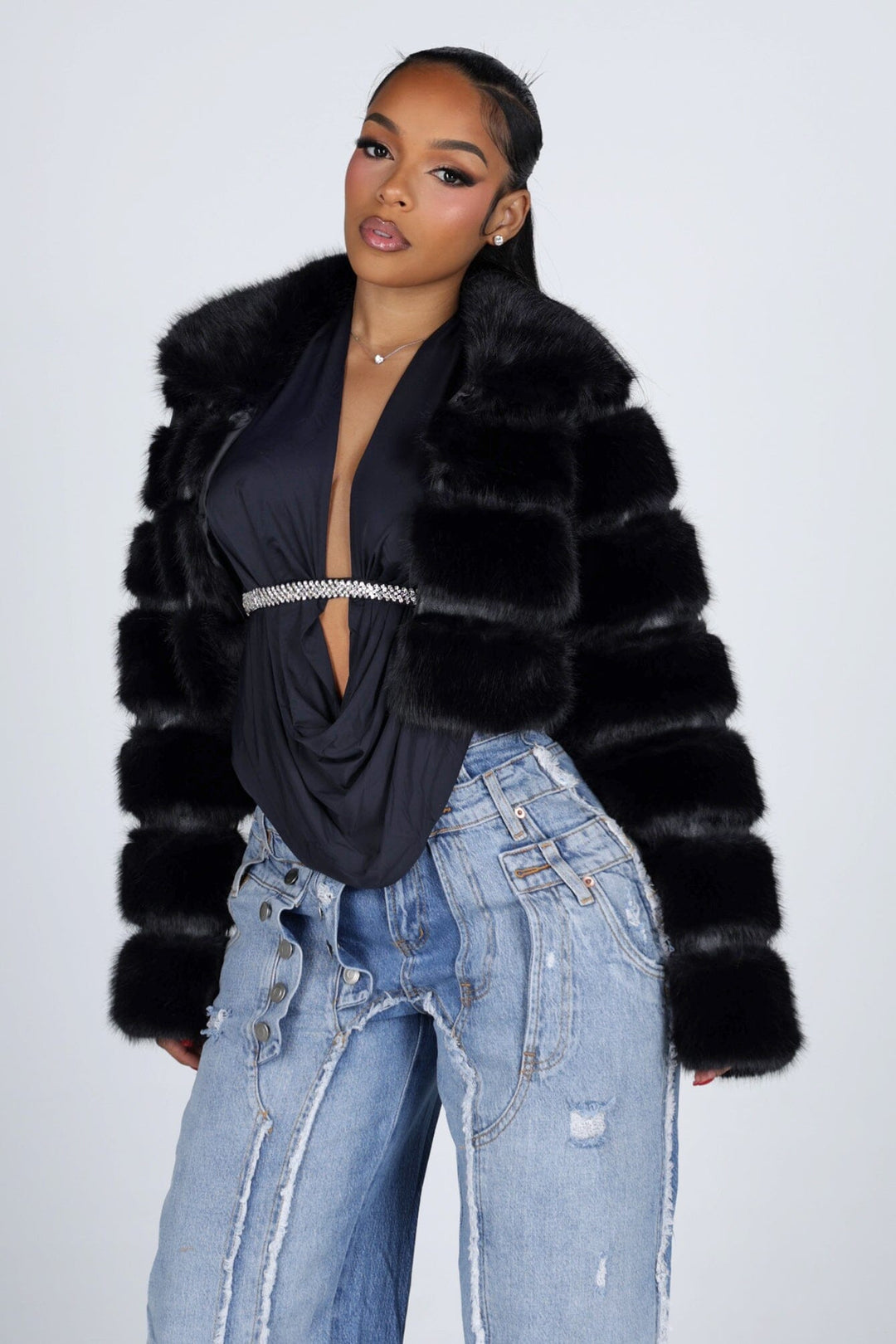 Cropped faux fur jacket with a notched collar featuring tiered segmented fur and long sleeves
