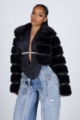 Cropped faux fur jacket with a notched collar featuring tiered segmented fur and long sleeves
