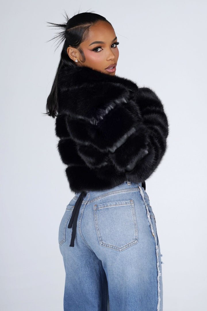 Cropped faux fur jacket with a notched collar featuring tiered segmented fur and long sleeves