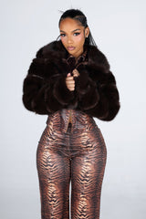 Cropped faux fur jacket with a notched collar featuring tiered segmented fur and long sleeves