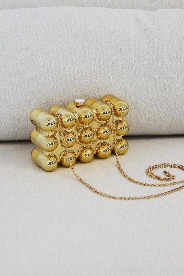 EDGE — gold bubble-textured mini clutch with chain strap, front view flat lay