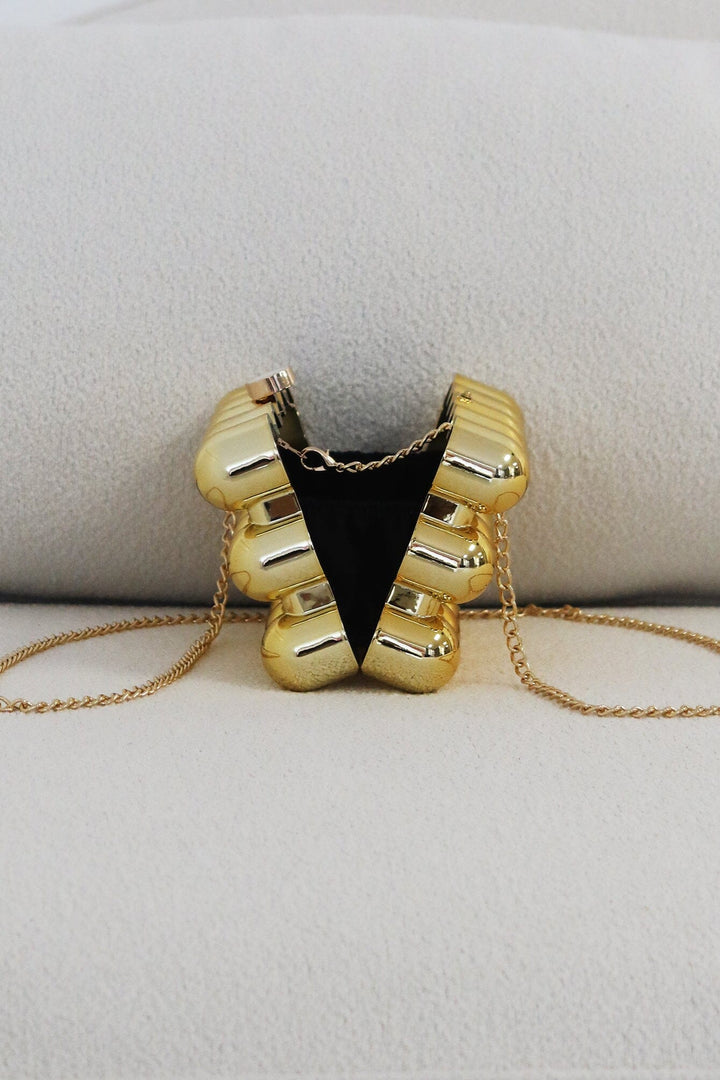 EDGE — gold bubble-textured mini clutch shown open from the back, flat lay