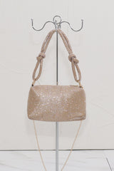EDGE — gold rhinestone-embellished top handle evening bag displayed on a stand