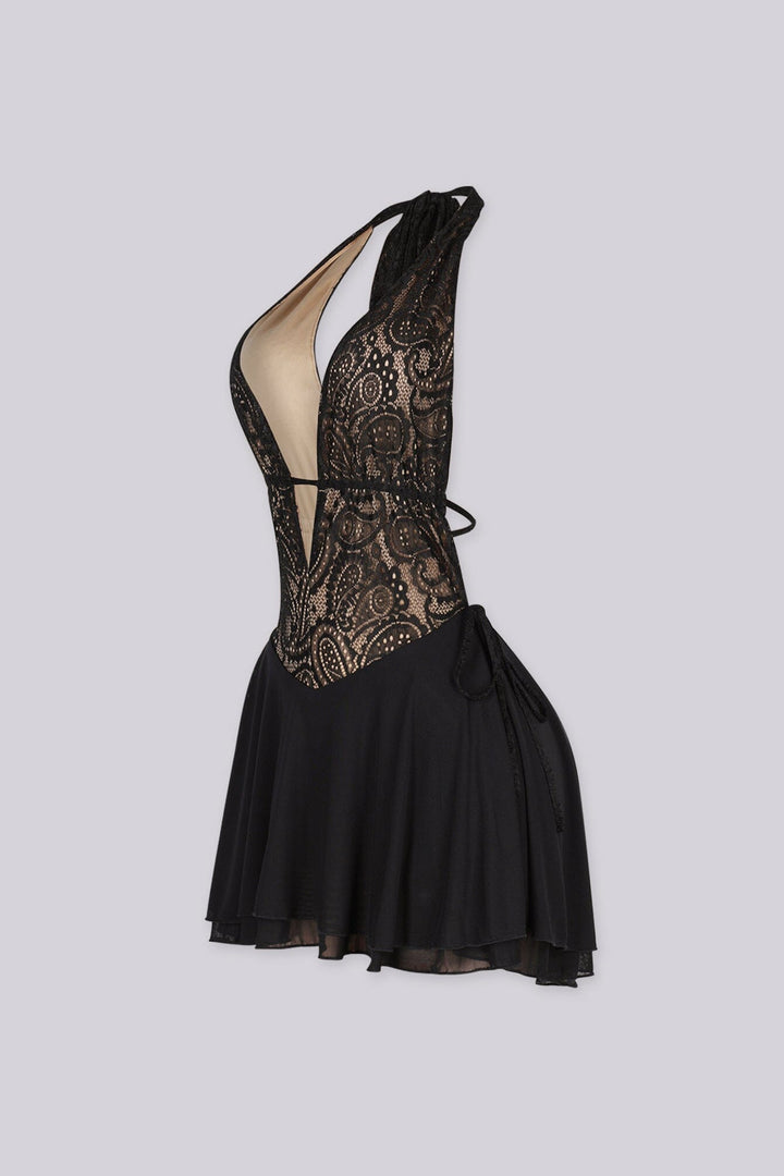 Halter mini dress featuring a deep v neckline, Nude illusion lace bodice, Flowy ruffled skirt and an open back with adjustable string ties