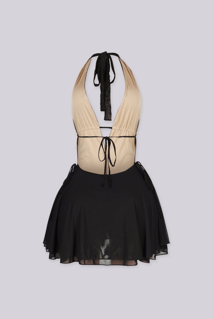 Halter mini dress featuring a deep v neckline, Nude illusion lace bodice, Flowy ruffled skirt and an open back with adjustable string ties