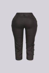 High rise capri denim pants with rows of decorative button trim running down each outer leg seam