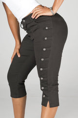 High rise capri denim pants with rows of decorative button trim running down each outer leg seam