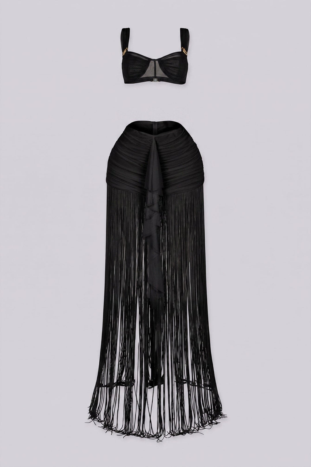 Bralette crop top featuring a gold hardware bralette,
Matching set with ruched mini skirt with floor length fringe