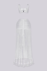 Bralette crop top featuring a gold hardware bralette,
Matching set with ruched mini skirt with floor length fringe