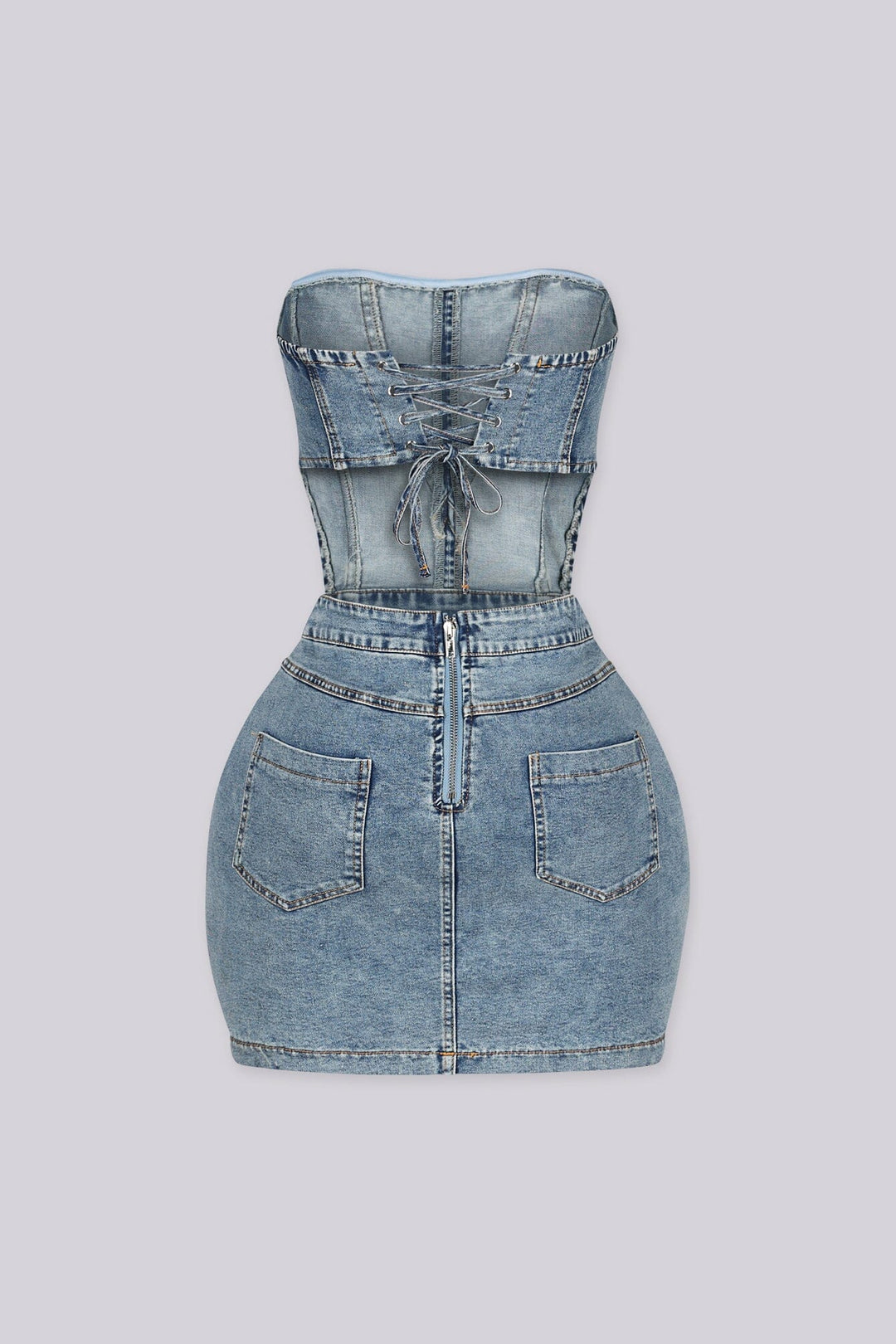 Strapless corset bodice denim mini dress with a lace up back
Open waistline and finished with&amp;chunky hardware buckle straps