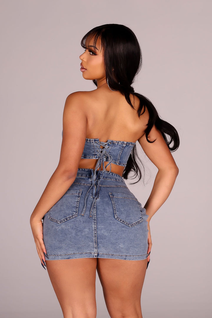 Strapless corset bodice denim mini dress with a lace up back
Open waistline and finished with&amp;chunky hardware buckle straps