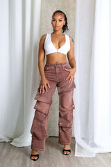 High waist wide leg jeans featuring multiple overlapping fabric flaps with metallic snap buttons
