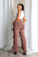 High waist wide leg jeans featuring multiple overlapping fabric flaps with metallic snap buttons