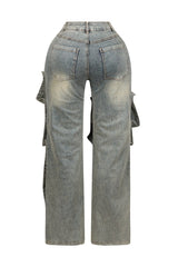 High waist wide leg jeans featuring multiple overlapping fabric flaps with metallic snap buttons