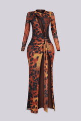 Leopard print long sleeve fitted maxi dress with round neckline featuring diagonal chest cutout and gathered waist with gold bar deatil