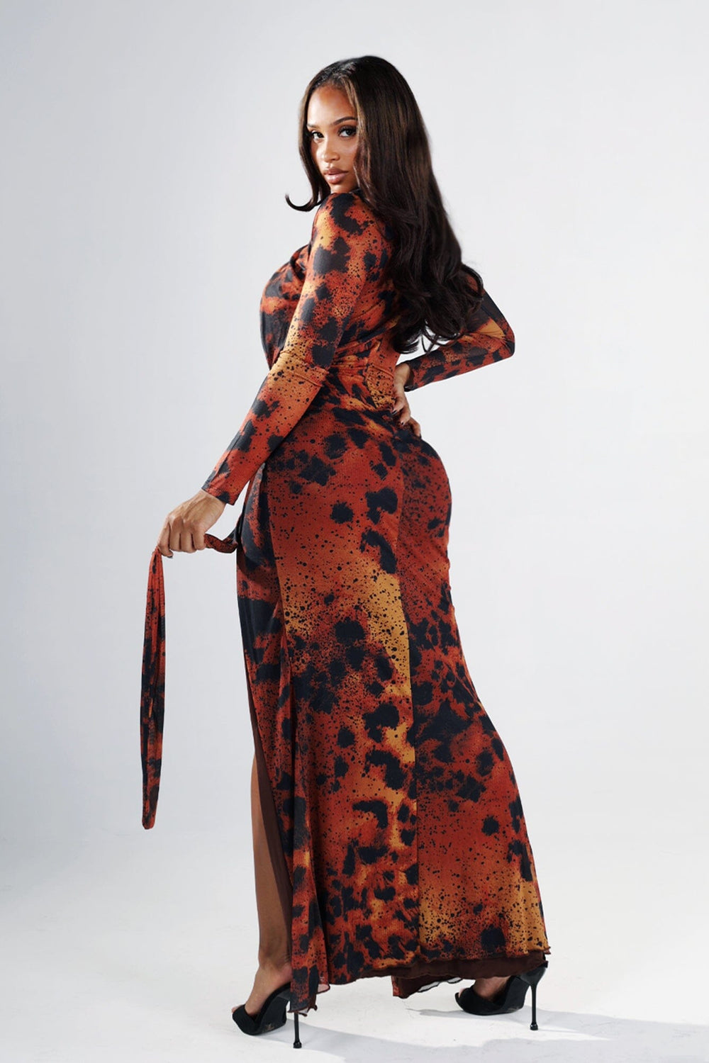 Leopard print long sleeve fitted maxi dress with round neckline featuring diagonal chest cutout and gathered waist with gold bar deatil