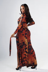 Leopard print long sleeve fitted maxi dress with round neckline featuring diagonal chest cutout and gathered waist with gold bar deatil