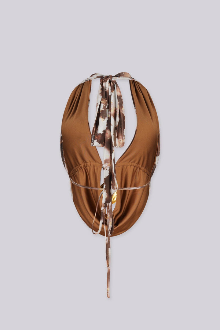 Deep plunging halter top with gold ring hardware at the center