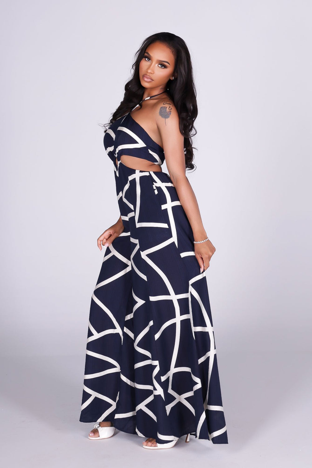 Linen abstract print wide leg halter jumpsuit featuring cutout waist with a square detail at the center