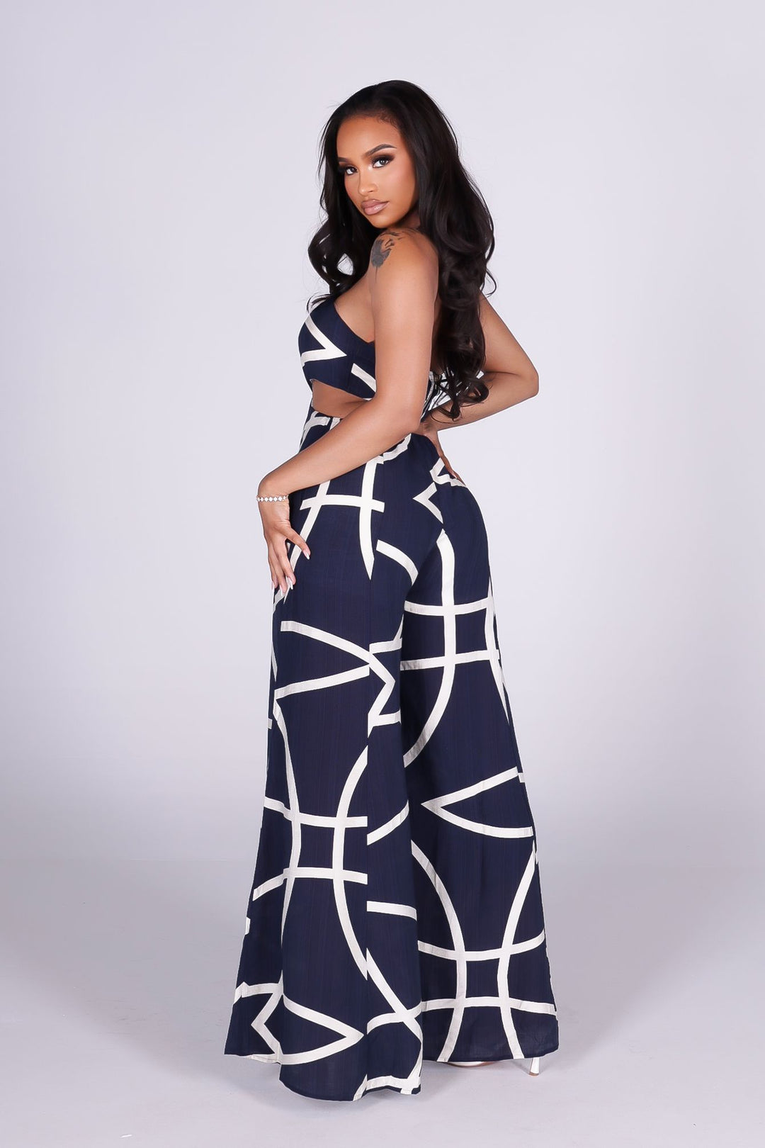 Linen abstract print wide leg halter jumpsuit featuring cutout waist with a square detail at the center