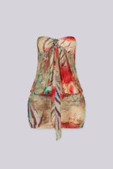 Abstract print tube mini dress featuring draped front detail with a metal accent and subtle volume through the waist