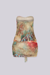 Abstract print tube mini dress featuring draped front detail with a metal accent and subtle volume through the waist