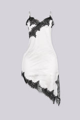 Asymmetrical hemline mini dress with v neckline and spaghetti straps featuring black lace trim