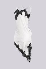 Asymmetrical hemline mini dress with v neckline and spaghetti straps featuring black lace trim
