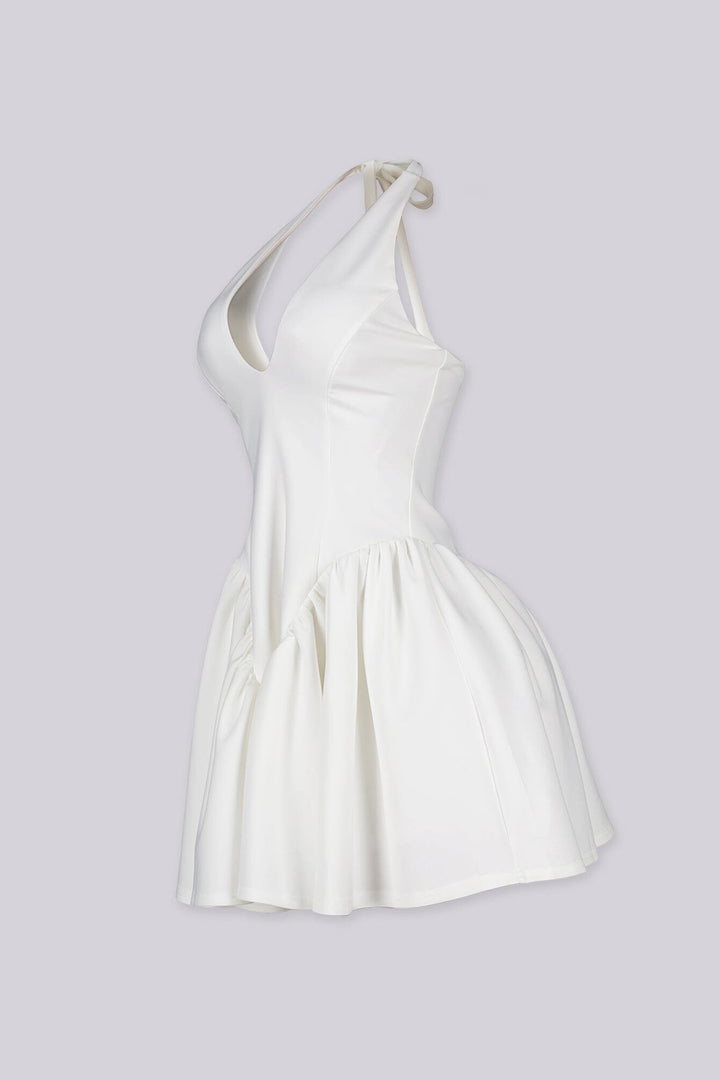 Fitted bodice halter neck mini dress with plunging v neckline featuring drop waist seams for flared swing hem