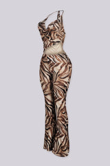 Cowl neck halter top jumpsuit with chain strap detail at one shoulder, side view