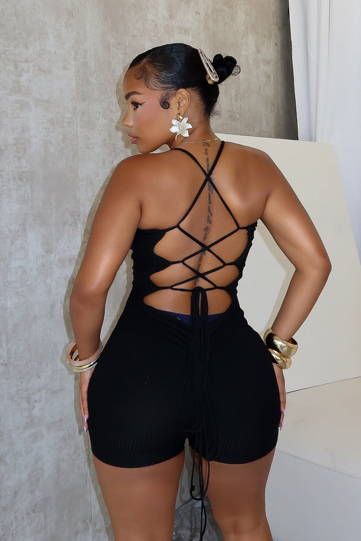 Ribbed knit sleeveless romper with deep V-neck featuring double straps and lace up back
Vertical center seam with ruched and cinches for contouring