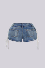 Low rise denim shorts with crisscross rope lacing through metal eyelets detailing