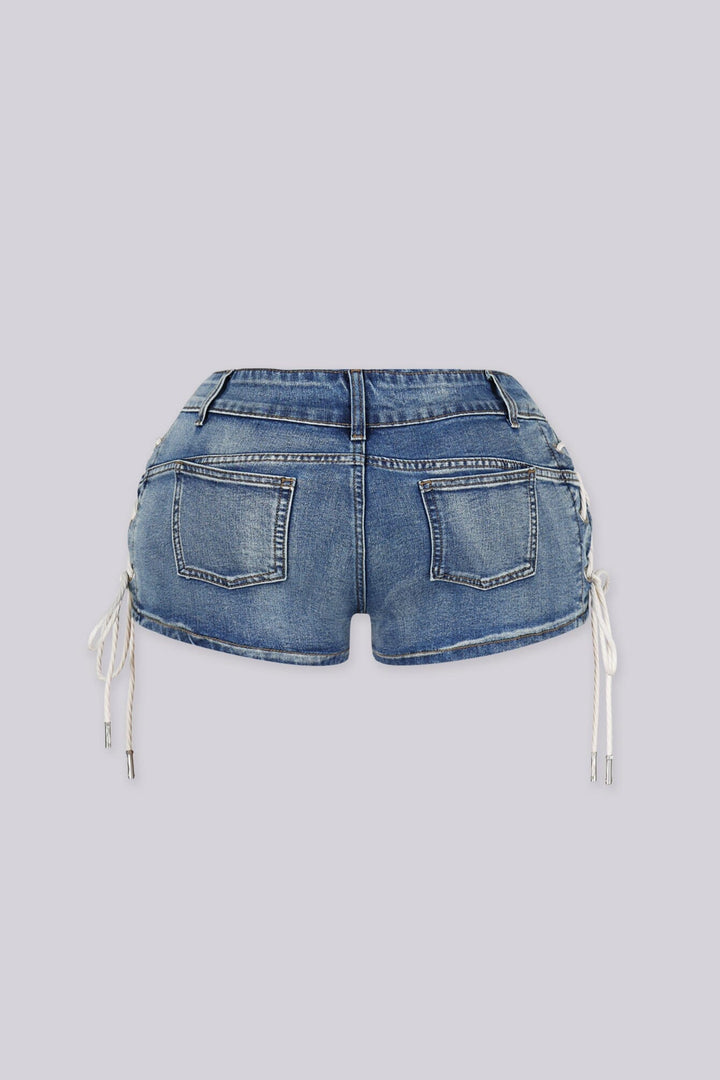 Low rise denim shorts with crisscross rope lacing through metal eyelets detailing