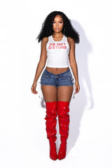 Low rise denim shorts with crisscross rope lacing through metal eyelets detailing